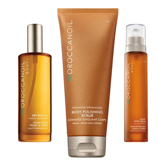 Moroccanoil Body Care kroppspleiesett som gir fuktighet og glød i ravfargede flasker og en skimrende bronsefarget tube.