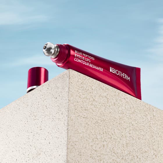 Biotherm Blue Peptides Eyes Lips 15 ml oppstrammende pleie i rød krukke og tube svevende på røde bånd mot blå himmel