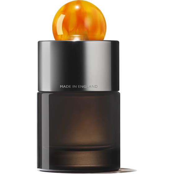 Molton Brown Sunlit Clementine & Vetiver EdP 100 ml tummassa lasipullossa oranssilla pallokorkilla ja pakkauksella