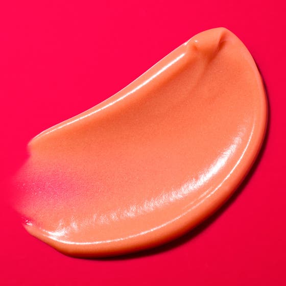 Nuxe Merveillance Lift Glow 50 ml kiinteyttävä päivävoide punaisessa tuubissa persikkaisen voiteen päällä