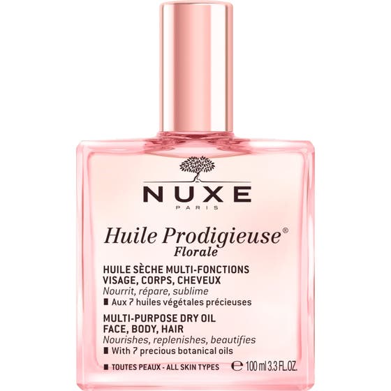 Nuxe Huile Prodigieuse Florale 100 ml nærende tørrolje i rosa glassflaske med spraypumpe og løs metallisk kork