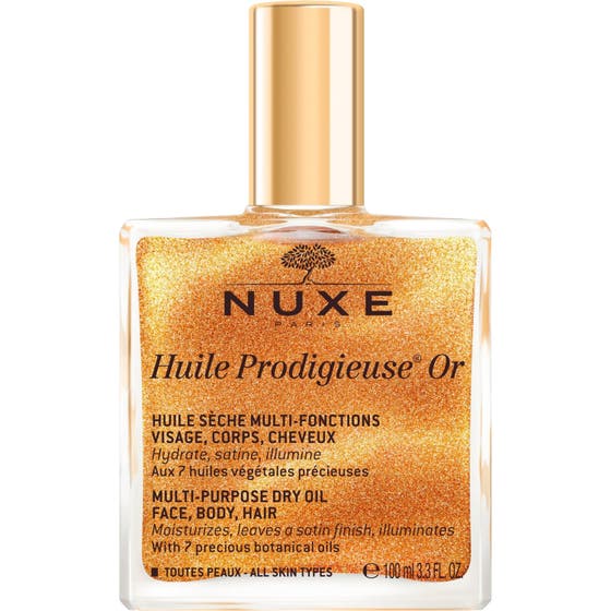 Nuxe Huile Prodigieuse Or 100 ml heleyttävä kuivaöljy kultaisella hohdolla neliönmuotoisessa lasipullossa.