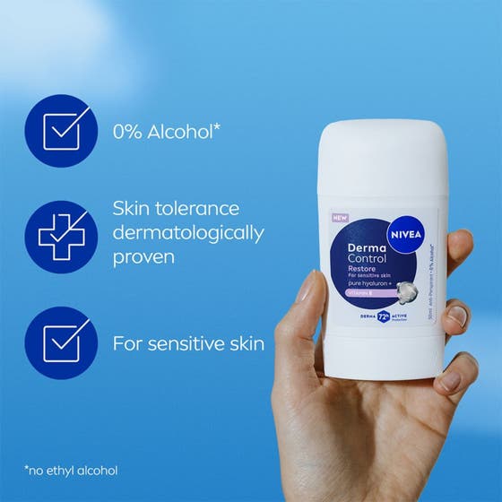 NIVEA Antiperspirant Deo Stick Derma Control Restore 50 ml för känslig hud i vit hylsa som hålls mot blå bakgrund.