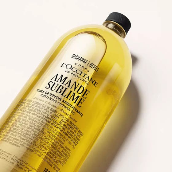 L'Occitane Almond Shower Oil 500 ml blødgørende badeolie i gennemsigtig genopfyldningsflaske med sort låg